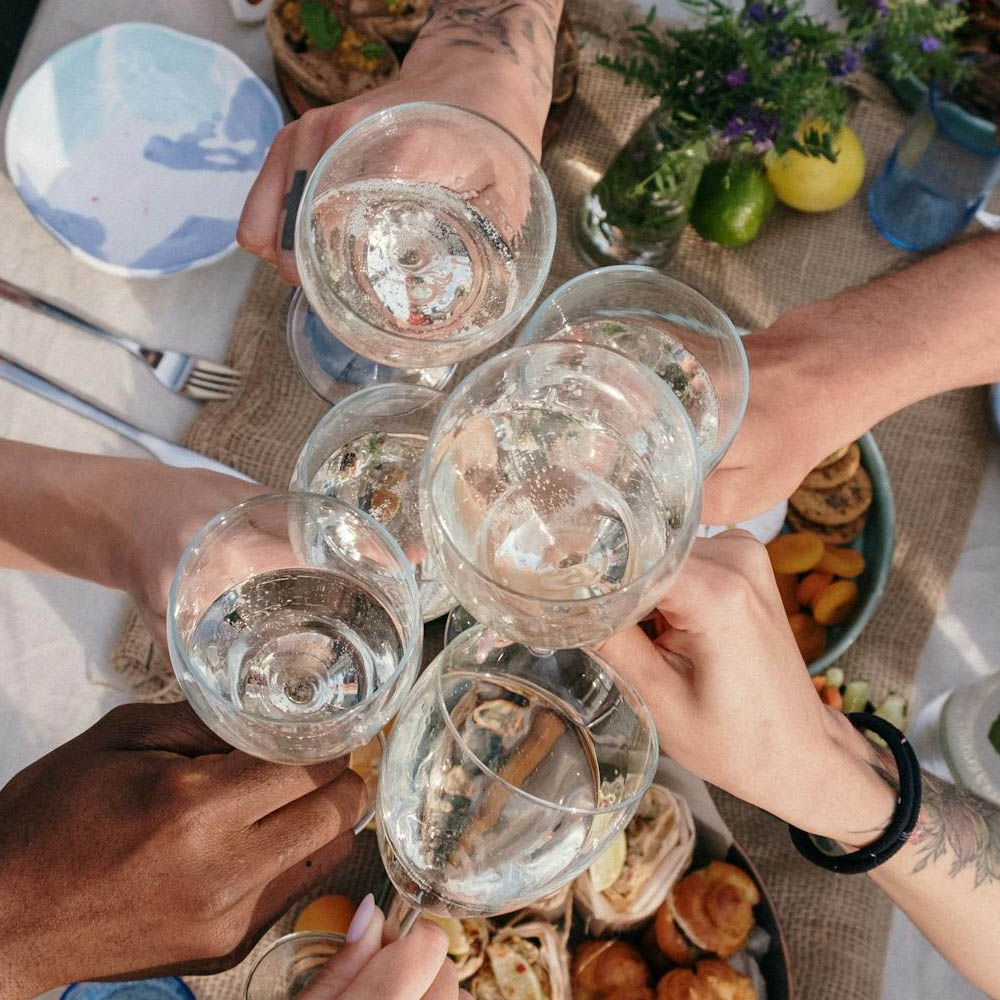 Group clinking glasses together. Top view looking down.