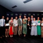 Group of people and their awards at the UNE Sports Award ceremony