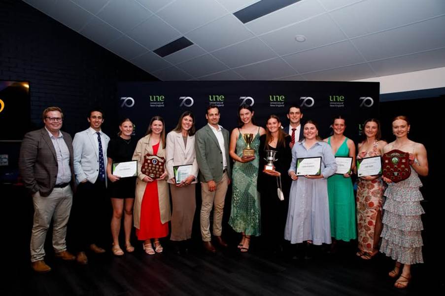 Group of people and their awards at the UNE Sports Award ceremony